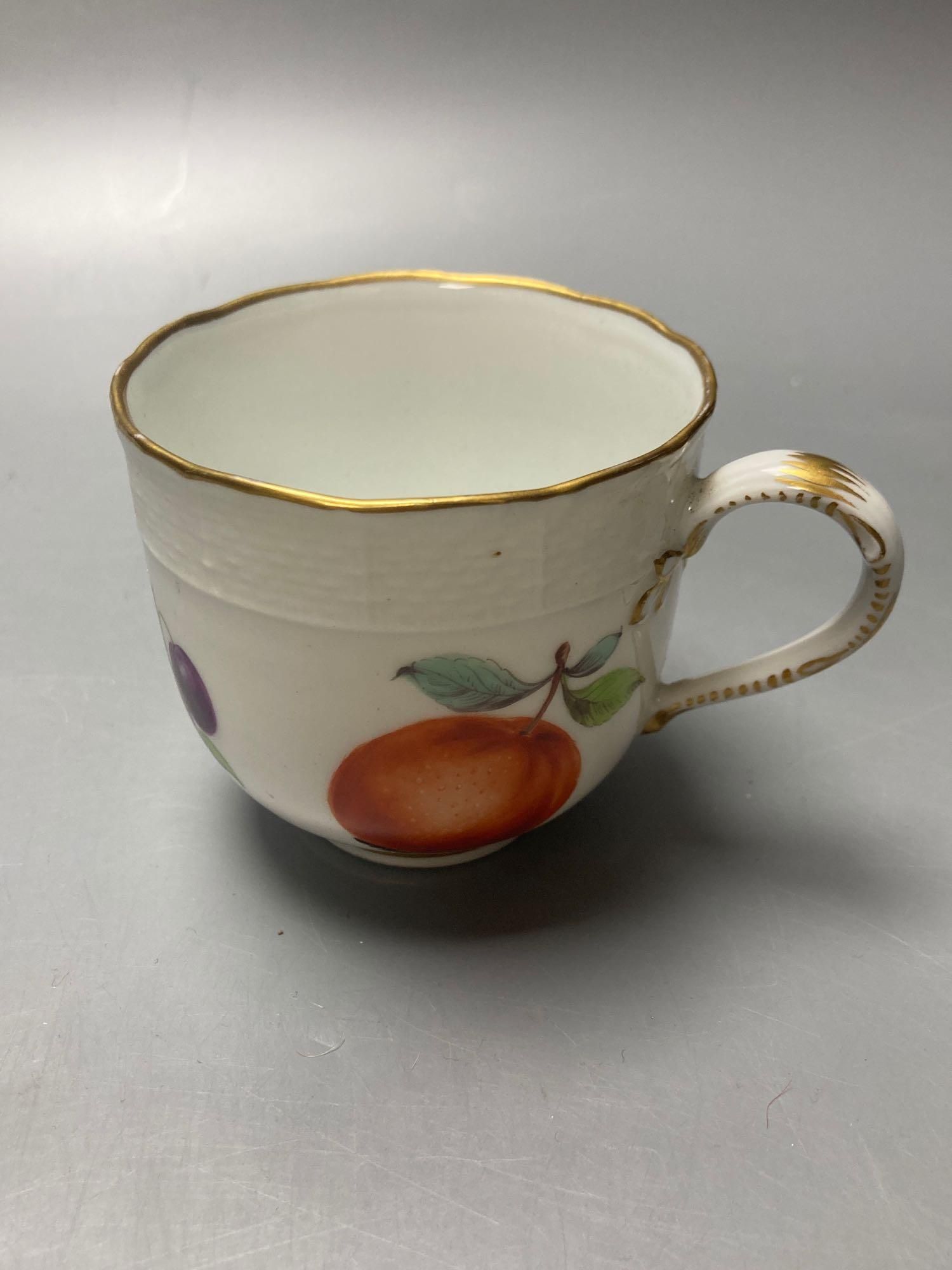 A Meissen cup and saucer, factory seconds, decorated with fruit and butterflies and lined with gilt